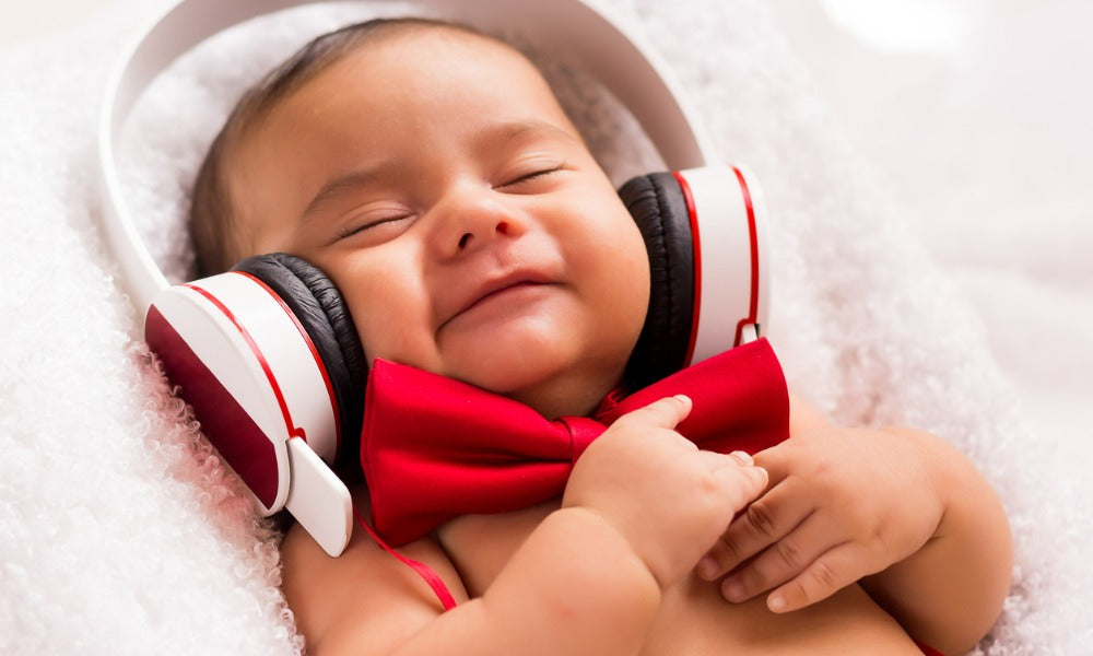 A baby smiling while listening to music for newborns 